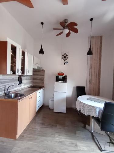 a kitchen with a table and a ceiling fan at Apartments 2 Ivanković in Stari Grad