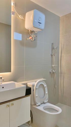 a bathroom with a white toilet and a sink at Montage Villa near Beach with Golf View in Nongsa
