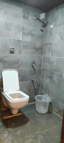 a bathroom with a toilet and a shower at Hotel Vaithi Residency - Andheri West in Mumbai