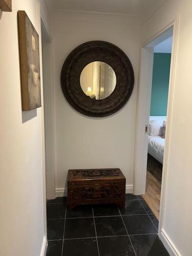 a room with a mirror on the wall and a stool at Cosy 2 Double Bed Apartment in Swords