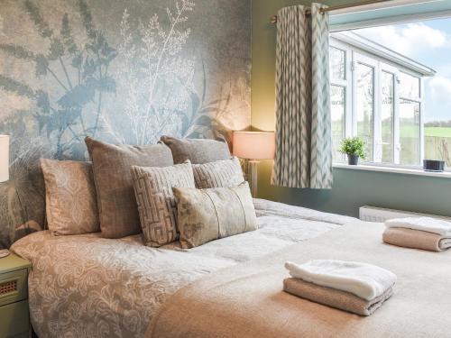 a bedroom with a large bed with a window at Shirleys Place in Boston Spa