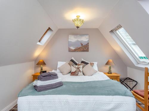 a bedroom with a large bed in a attic at The Old Stables - Uk46338 in Canisbay
