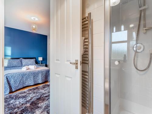 a bedroom with a bed and a shower at Bluegrass Retreat On The River Ness in Inverness