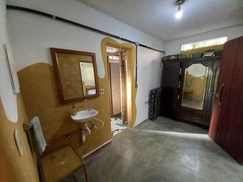 a bathroom with a sink and a mirror at Sitio Humanaterra: natureza e acolhimento. in São Lourenço da Serra
