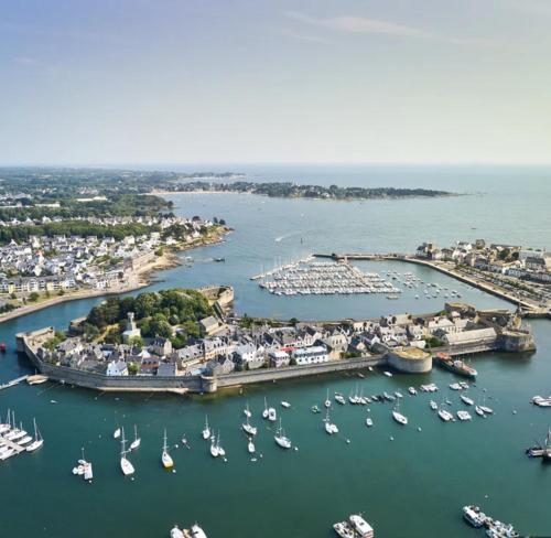 an aerial view of a harbor with boats in the water at L’Hermine, parking & terrasse in Concarneau