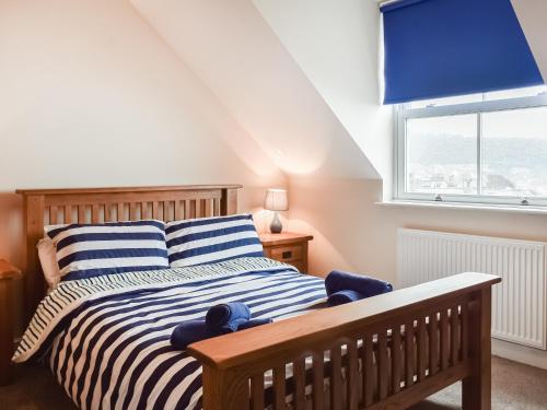 a bedroom with a bed with a blue window at Top O The Brewery in Scarborough