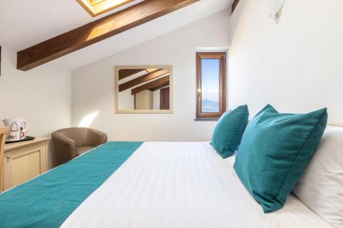 a bedroom with a large white bed with blue pillows at Casale Antonietta in Sorrento