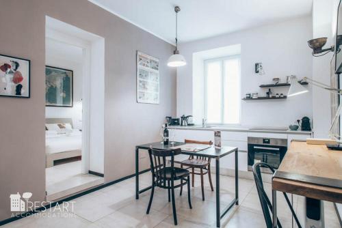 羅馬的住宿－Restart Accommodations Aldobrandini e Sciarra，厨房以及带桌椅的用餐室。