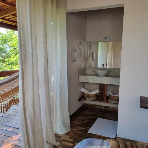 a bathroom with a sink and a mirror at Pousada Bambuí Terra Ronca in São João