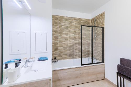a bathroom with two sinks and a shower at Confort Moderne Argenteuil – Proche Paris in Argenteuil