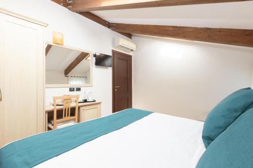 a bedroom with a bed and a small kitchen at Casale Antonietta in Sorrento