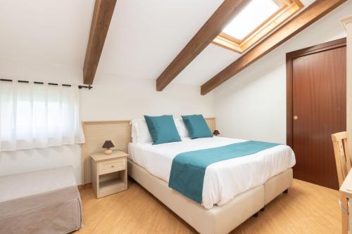 a bedroom with a large bed with blue pillows at Casale Antonietta in Sorrento