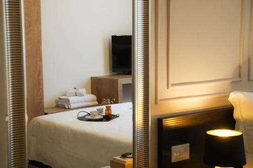 a hotel room with a bed and a mirror at Mazzini's Rooms in Modena