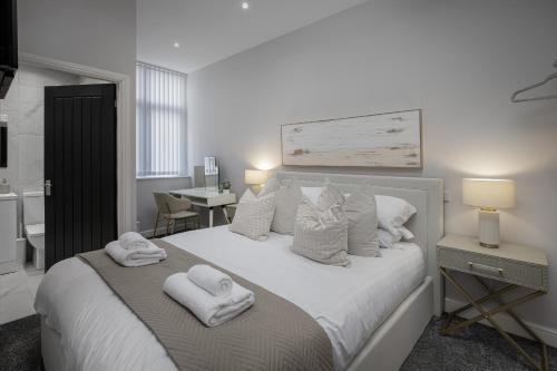 a bedroom with a bed with towels on it at The 1878 by STAMP SA in Blackpool
