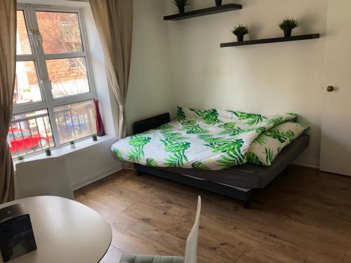 a bedroom with a bed and a table and two windows at Dublin Dreamer in Dublin