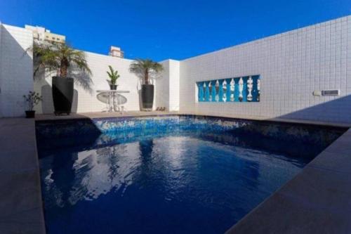 a swimming pool in front of a building at HOSTEL e POUSADA SALVADOR PRAIA in Salvador