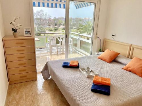 a bedroom with a bed with a view of a balcony at APARTBEACH ARRECIFE y FRENTE PLAYA in La Pineda