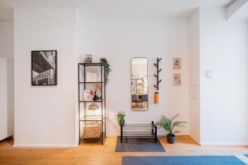 a living room with a bench and a mirror at Urban Retreat - City Center Apartment in central Berlin BY HOMELY in Berlin
