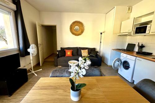 a living room with a couch and a table at Les Naïades D15- 2 bedrooms for 5 people ! in Avène