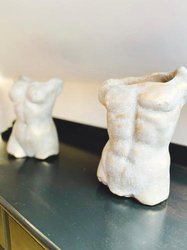two white sculptures sitting on top of a table at Exclusive BDSM Apartment Kraków - ADULTS ONLY in Kraków