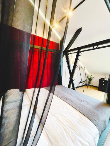 a large bed in a room with a red and white bedspread at Exclusive BDSM Apartment Kraków - ADULTS ONLY in Kraków