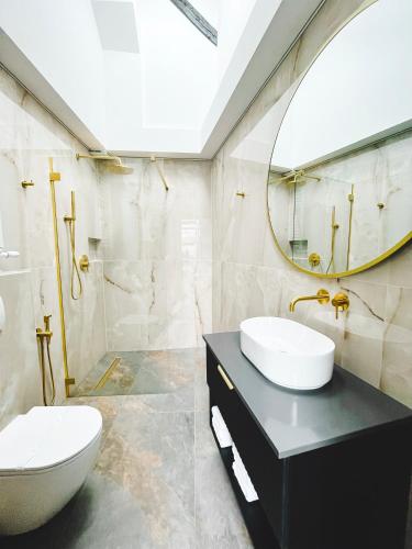 a bathroom with a sink and a mirror at Exclusive BDSM Apartment Kraków - ADULTS ONLY in Kraków
