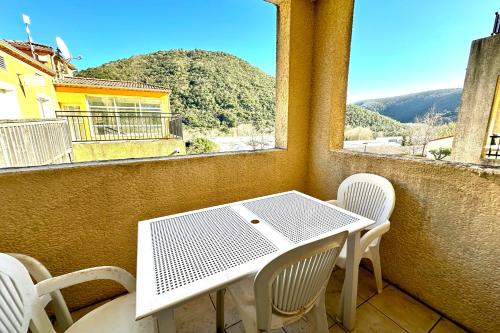 a table and chairs on a balcony with a view at Les Naïades E20 - 2 bedrooms for 5 people ! in Avène