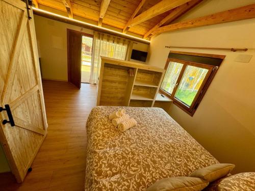 a bedroom with a bed and a large wooden door at Alojamiento Rural La Alberca in Arguedas