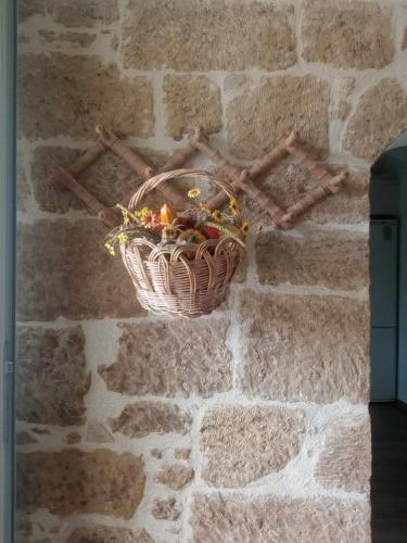 a basket hanging on a stone wall at Old Mansion Residence in Riglia