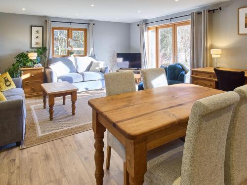 a living room with a wooden table and chairs at Host & Stay - Orchard Barn in Ashford