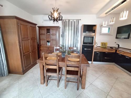 a kitchen with a table and chairs and a dining room at GREEN VILLAGE Apartment in Gornji Orahovac