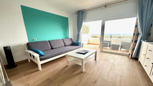 a living room with a couch and a table at Welooveyou Zafiro's in Morro del Jable