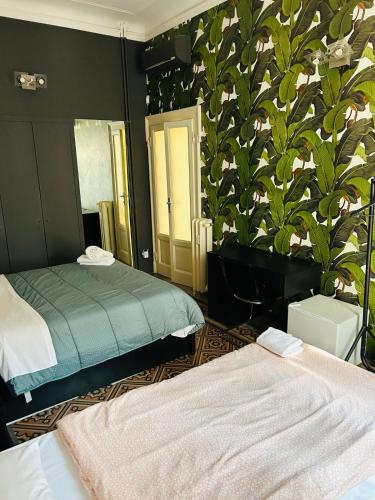 a bedroom with two beds and a plant wall at B&B Boutique in Milan