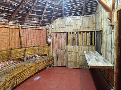 a room with wooden benches in a barn at Livi Homestay in Ambalavayal