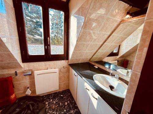 a small bathroom with a sink and a mirror at LIAGE - La Maison qui relie in Saint-Marcel