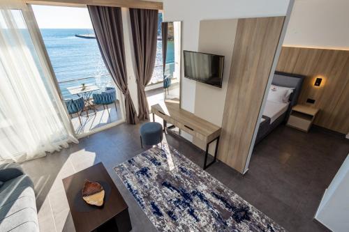 a hotel room with a bed and a view of the ocean at Continental Hotel in Ulcinj