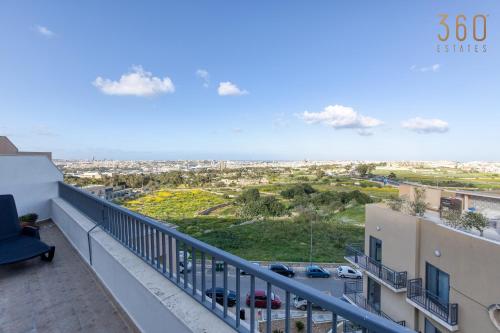 a balcony with a view of a parking lot at Beautiful PENT with terrace & spectacular views by 360 Estates in Luqa