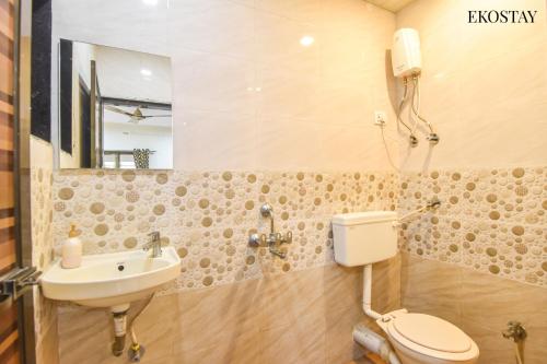 a bathroom with a toilet and a sink at EKOSTAY - Simba Villa in Karjat