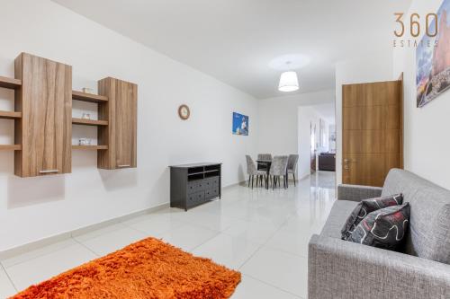 a living room with a couch and a fireplace at Beautiful PENT with terrace & spectacular views by 360 Estates in Luqa