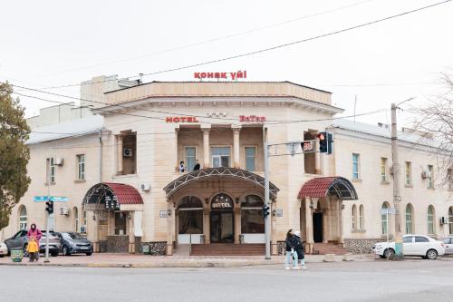 a building on the corner of a street at Hotel ВаYan in Shymkent