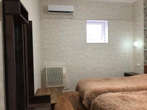 a hotel room with two beds and a television at Nato & Lado in Sighnaghi