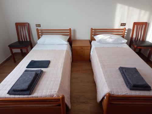 two beds in a room with two chairs at B&B Primo Marzo in Volargne