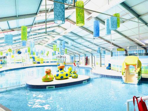 a large indoor swimming pool with some toys in it at Dunlin Retreat in Flamborough