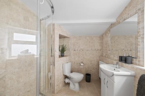 a bathroom with a toilet and a sink at Fabulous House in Plymouth in Plymouth