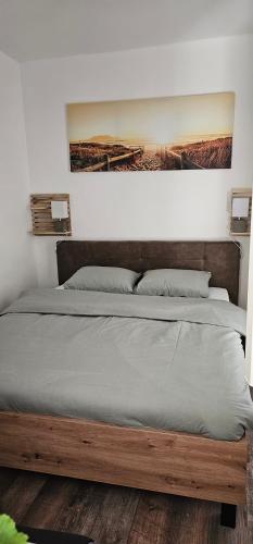 a bed with a wooden frame in a bedroom at Apartman Pontica in Kotor