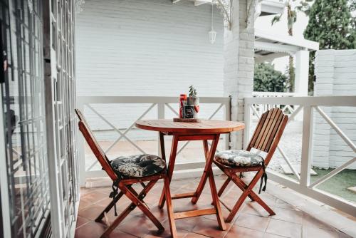 a table and two chairs on a porch at Amaziah Guesthouse in Kuruman