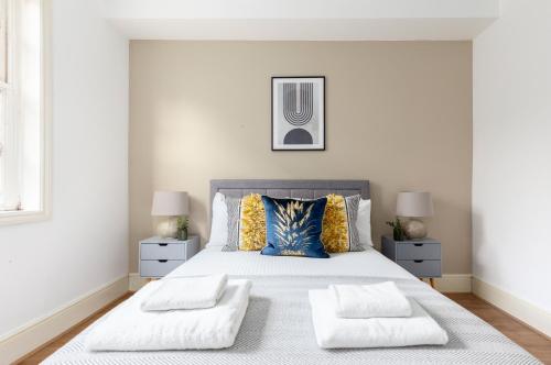 a bedroom with a large bed with two pillows at The Haggerston Collection in London
