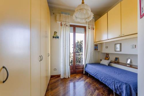 a bedroom with a blue bed and a window at L22 Casa Belvedere in Marcelli