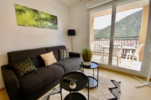 a living room with a couch and a large window at Les Naïades I52 - 2 bedrooms for 5 people ! in Avène