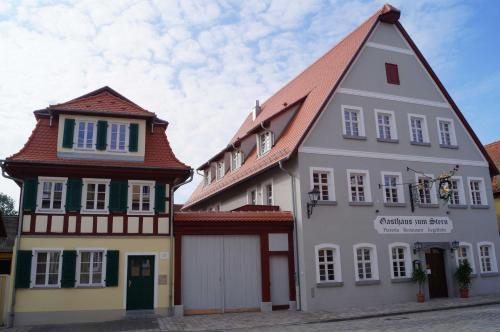 a white building with a red roof at Braumeister Döbler - Ferienwohnungen in Bad Windsheim